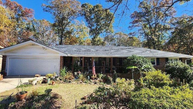 2479 Landeau Cir, Tucker, GA 30084 - ranch-style home with an attached garage, concrete driveway, brick siding, and a sunroom