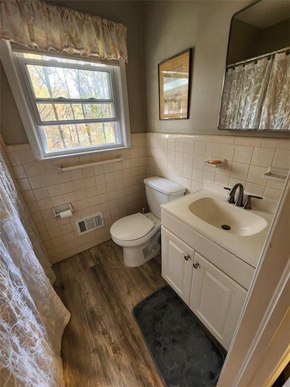 2479 Landeau Cir, Tucker, GA 30084 - full bath with tile walls, toilet, vanity, wood finished floors, and wainscoting