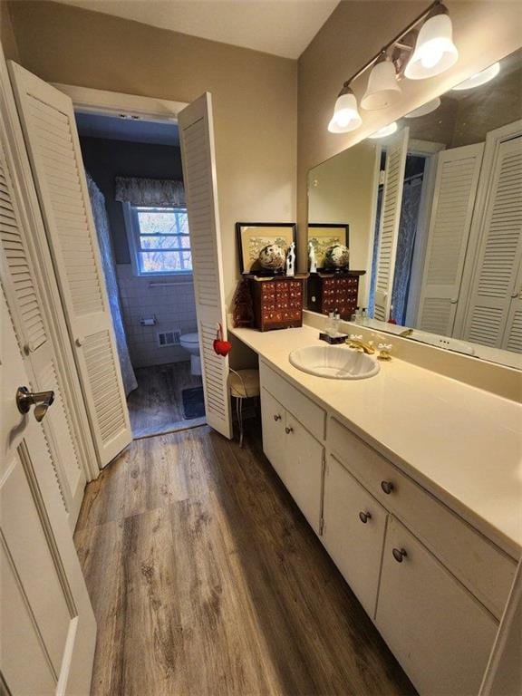 2479 Landeau Cir, Tucker, GA 30084 - full bathroom with a closet, wood finished floors, vanity, and toilet