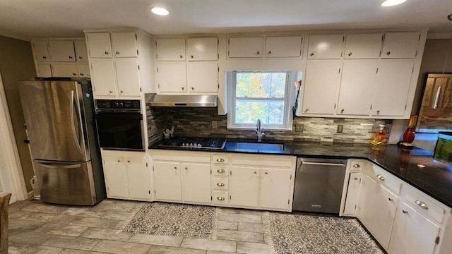 2479 Landeau Cir, Tucker, GA 30084 - kitchen featuring black appliances, under cabinet range hood, a sink, tasteful backsplash, and recessed lighting
