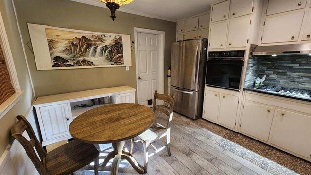2479 Landeau Cir, Tucker, GA 30084 - dining area with ornamental molding and light wood-style floors