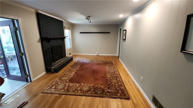 2479 Landeau Cir, Tucker, GA 30084 - unfurnished living room featuring wood finished floors, a fireplace, baseboards, and ornamental molding