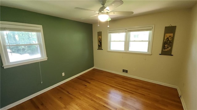 2479 Landeau Cir, Tucker, GA 30084 - empty room with wood finished floors, a ceiling fan, and baseboards