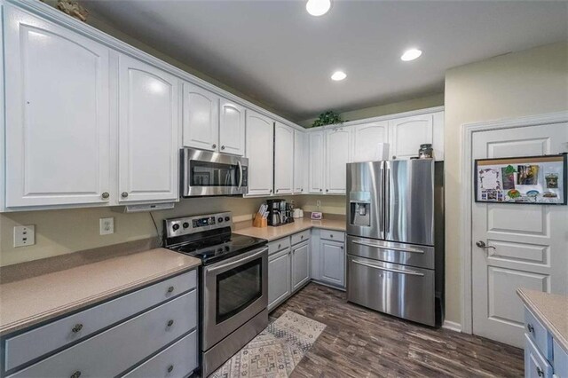 7835 Keepsake Ln, Flowery Branch, GA 30542 - kitchen featuring stainless steel appliances, dark wood finished floors, white cabinets, recessed lighting, and gray cabinets