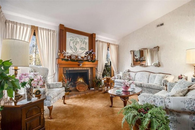 carpeted living room with plenty of natural light, lofted ceiling, and a fireplace