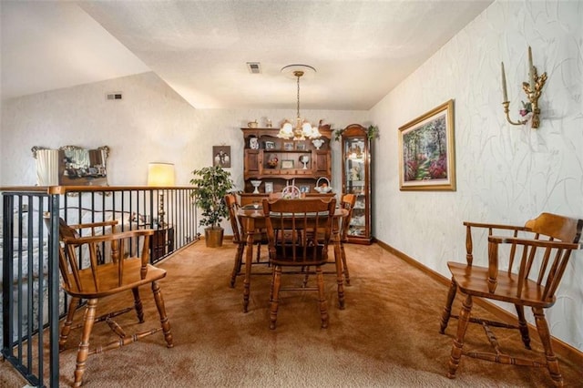 dining space with carpet flooring and a notable chandelier