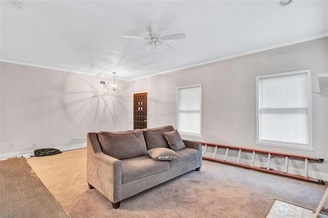 carpeted living room with ceiling fan and ornamental molding