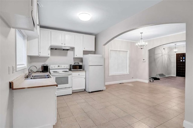 kitchen with decorative light fixtures, sink, white appliances, light tile patterned flooring, and white cabinets