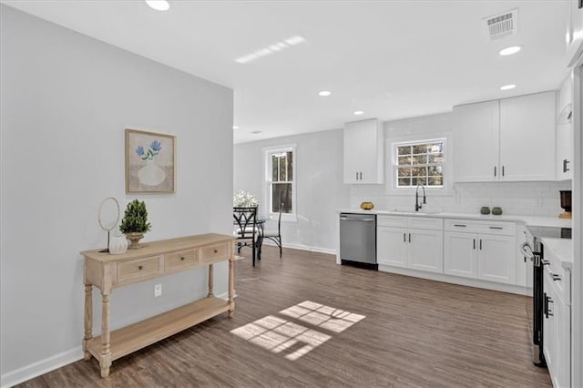 1766 Blossom Ln, Austell, GA 30168 - kitchen featuring white cabinets, appliances with stainless steel finishes, tasteful backsplash, visible vents, and dark wood-style floors
