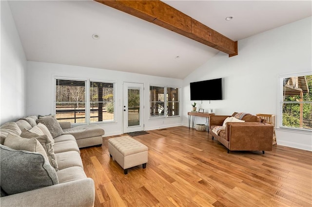 living room featuring vaulted ceiling with beams and light wood-type flooring