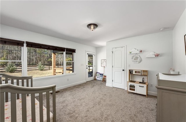 bedroom with a crib and carpet flooring