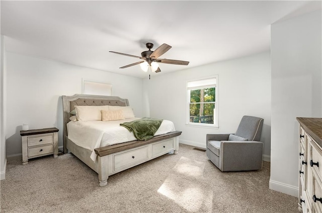 bedroom with ceiling fan and light colored carpet