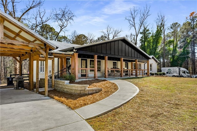 back of house featuring a porch and a yard