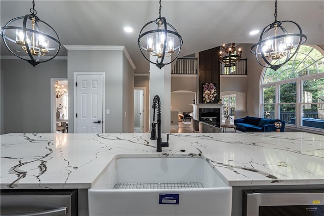 kitchen featuring a chandelier, wine cooler, open floor plan, and a sink