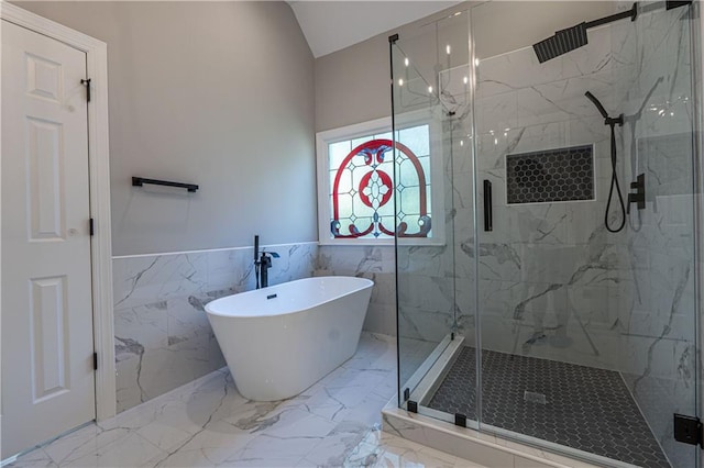 bathroom featuring a wainscoted wall, marble finish floor, a soaking tub, and a marble finish shower