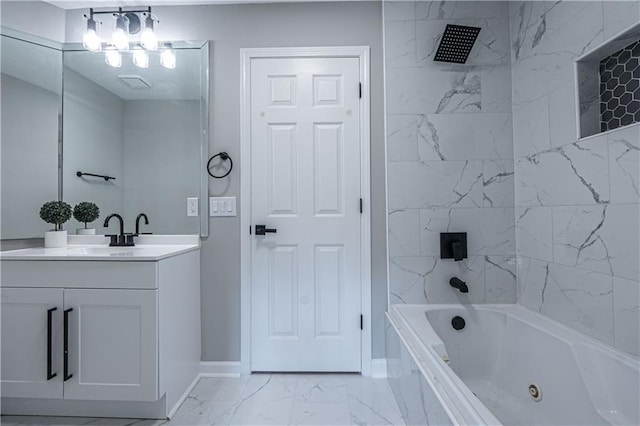 bathroom with marble finish floor, a combined bath / shower with jetted tub, vanity, and baseboards