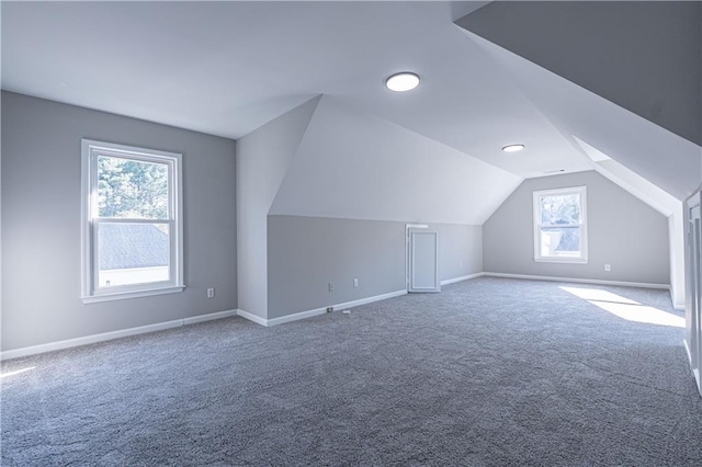 bonus room with carpet, baseboards, and vaulted ceiling