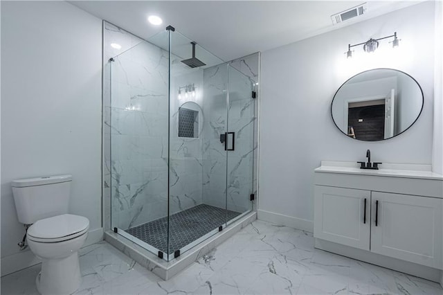 bathroom with marble finish floor, a marble finish shower, toilet, vanity, and baseboards