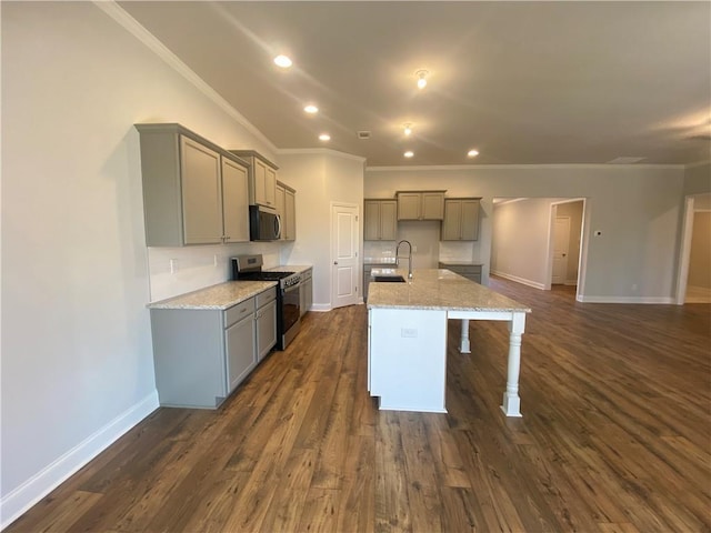 kitchen with sink, gray cabinets, a kitchen island with sink, stainless steel appliances, and light stone countertops