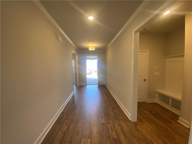 hall with ornamental molding and dark hardwood / wood-style floors