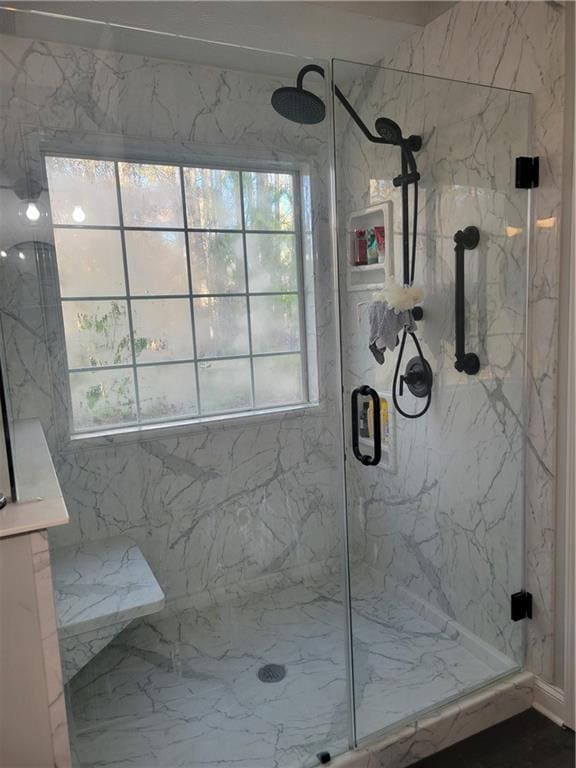 bathroom with a shower with door