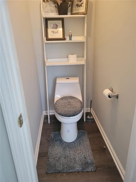 bathroom featuring hardwood / wood-style flooring and toilet