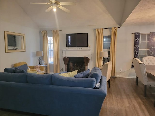 living room with hardwood / wood-style flooring, vaulted ceiling, and ceiling fan