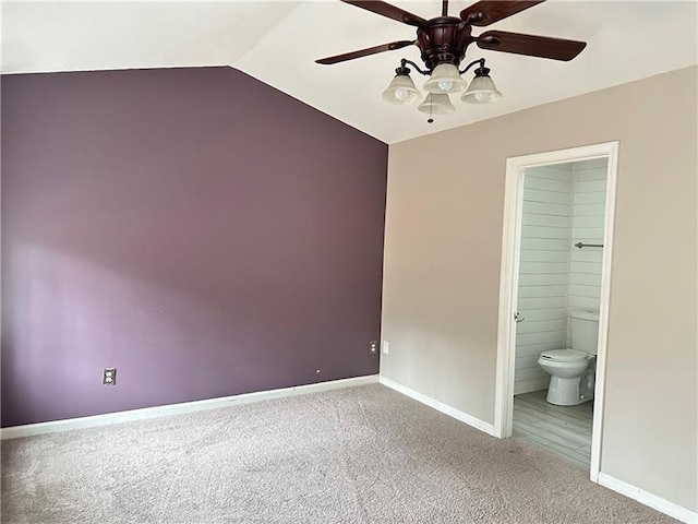 unfurnished bedroom featuring lofted ceiling, carpet floors, ensuite bath, and ceiling fan