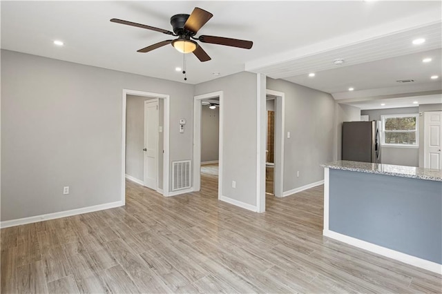 unfurnished living room featuring light wood-type flooring and ceiling fan