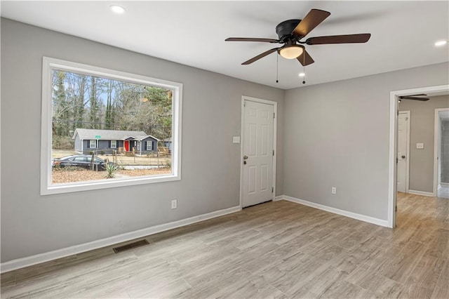 spare room featuring light wood-type flooring and ceiling fan