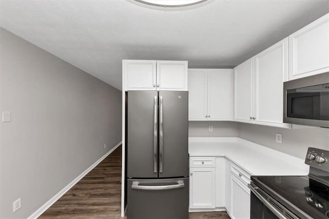 5514 E Stoneway Ct, Villa Rica, GA 30180 - kitchen with stainless steel appliances, white cabinets, light countertops, baseboards, and dark wood-style floors