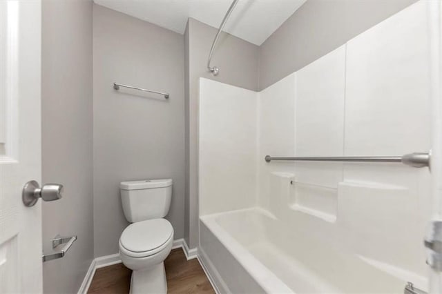 5514 E Stoneway Ct, Villa Rica, GA 30180 - full bath featuring toilet, wood finished floors, baseboards, and bathing tub / shower combination