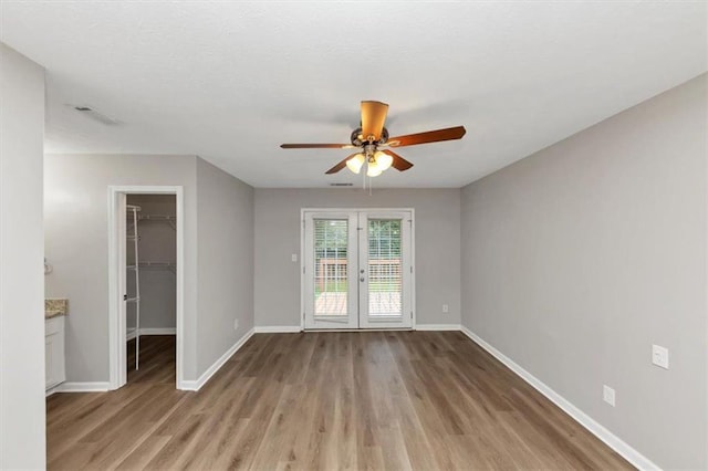 5514 E Stoneway Ct, Villa Rica, GA 30180 - empty room with wood finished floors, a ceiling fan, french doors, and baseboards