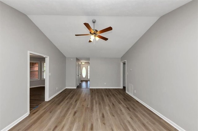 5514 E Stoneway Ct, Villa Rica, GA 30180 - unfurnished living room with lofted ceiling, a ceiling fan, wood finished floors, and baseboards