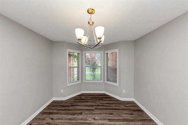 5514 E Stoneway Ct, Villa Rica, GA 30180 - empty room with a chandelier, dark wood-type flooring, and baseboards