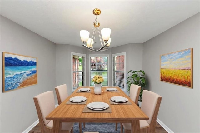 5514 E Stoneway Ct, Villa Rica, GA 30180 - dining room with a chandelier, baseboards, and wood finished floors