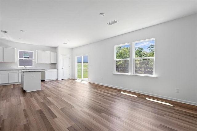 3019 Orwell Dr, Gainesville, GA 30507 - unfurnished living room featuring wood finished floors, baseboards, and a sink