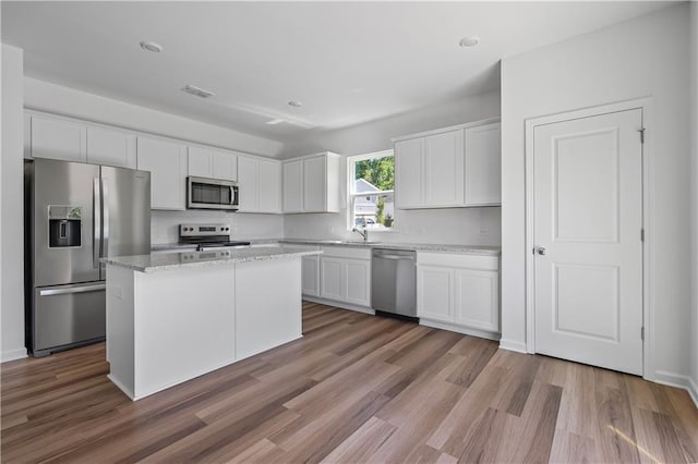 3019 Orwell Dr, Gainesville, GA 30507 - kitchen with appliances with stainless steel finishes, white cabinets, and light wood finished floors