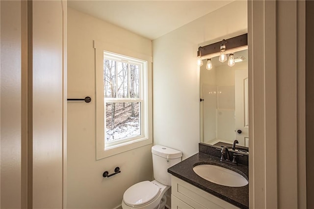 full bathroom with toilet, a shower, and vanity