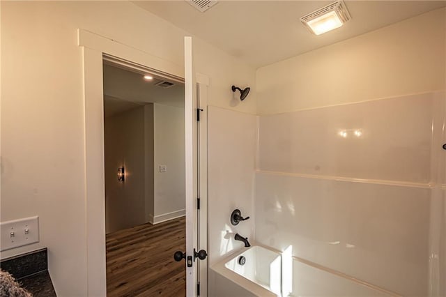 full bath featuring shower / bathtub combination, wood finished floors, and visible vents