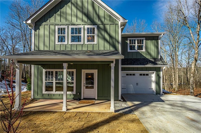 view of front of home with a garage, concrete driveway, a shingled roof, and board and batten siding