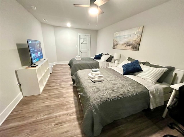 bedroom with hardwood / wood-style floors and ceiling fan