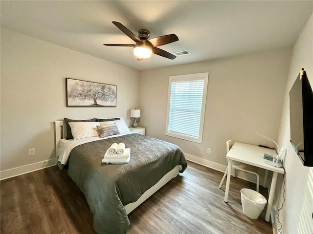 bedroom featuring ceiling fan and dark hardwood / wood-style floors