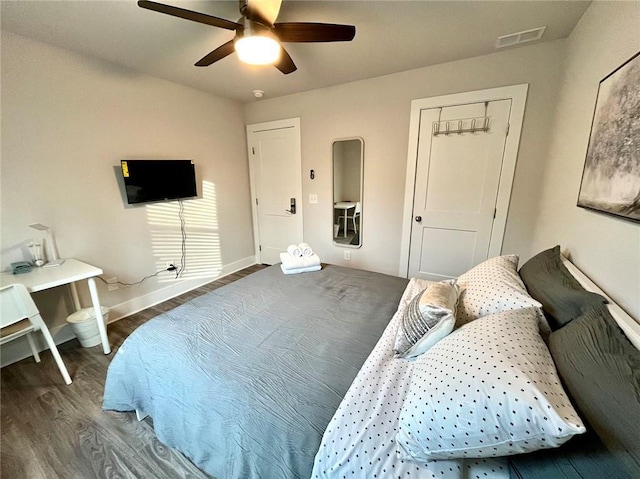 bedroom with ceiling fan and dark hardwood / wood-style floors