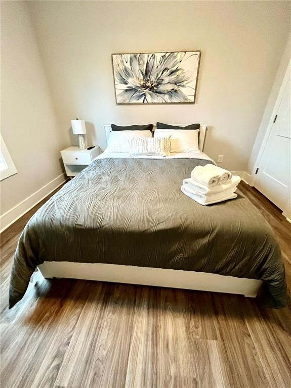 bedroom with hardwood / wood-style flooring