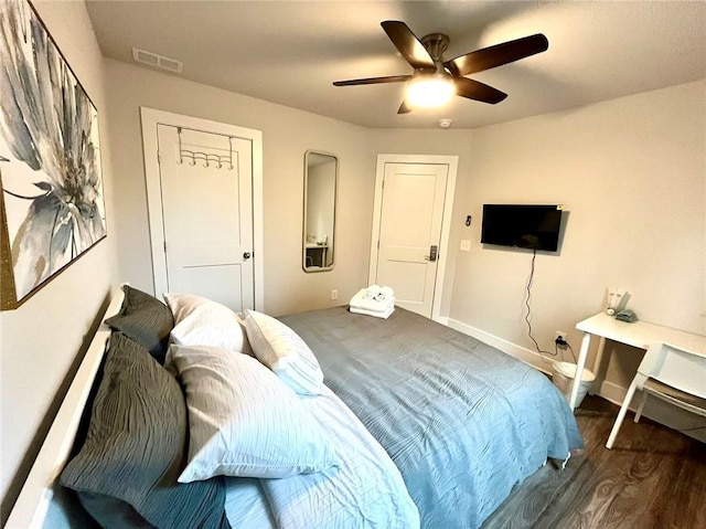 bedroom featuring ceiling fan and dark hardwood / wood-style floors