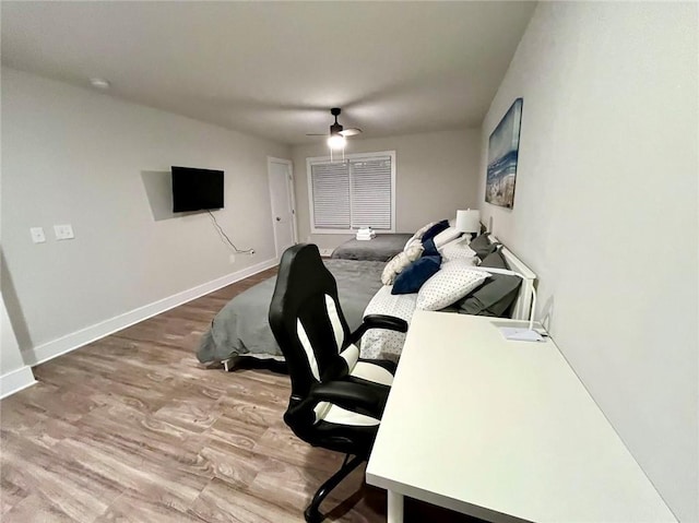 home office with hardwood / wood-style floors and ceiling fan