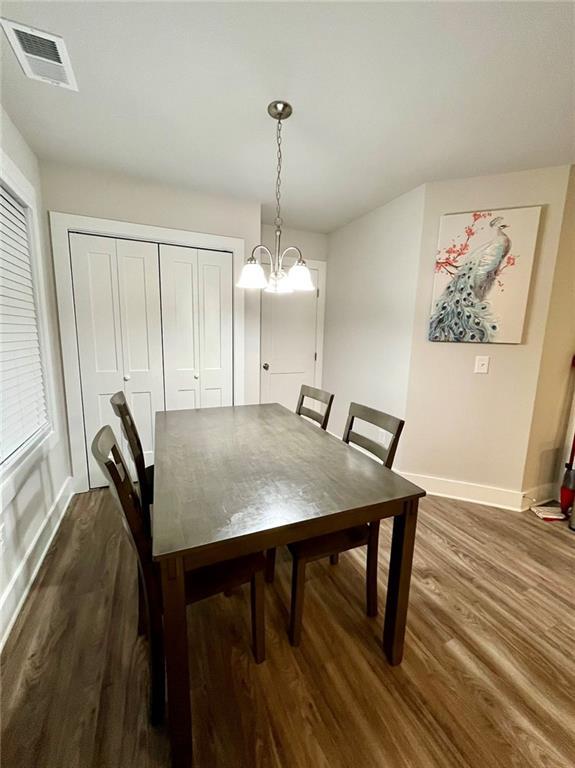 dining room featuring dark hardwood / wood-style floors and a notable chandelier