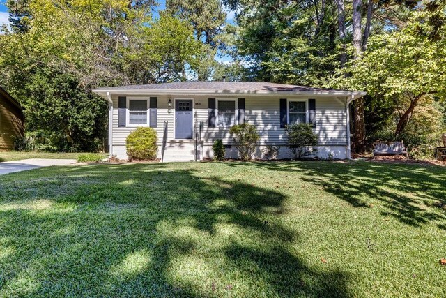 ranch-style house with a front lawn