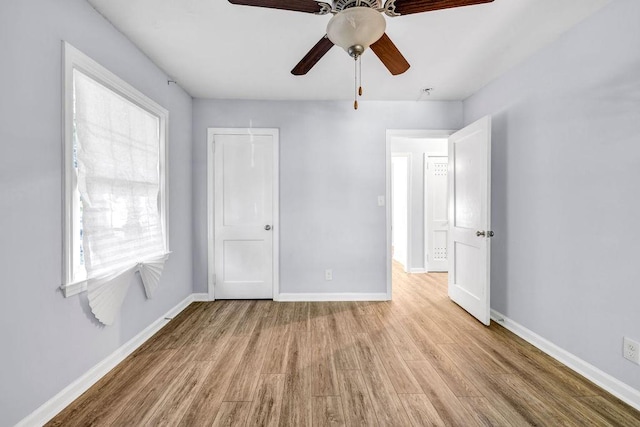 unfurnished bedroom featuring ceiling fan and light hardwood / wood-style flooring